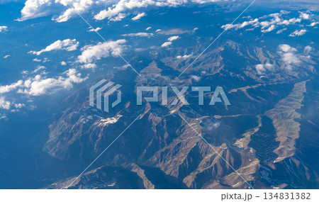 Aerial cloudy view. Landscape from plane. Top of mountain in cloud. Landscape with mountain in cloudy nature. Cloud and mountain peak aerial view. Travel concept. Aerial view of mountain landscape Aerial cloudy view. Landscape from plane. Top of mountain in cloud. Landscape with mountain in cloudy nature. Cloud and mountain peak aerial view. Travel concept. Aerial view of mountain landscape 134831382