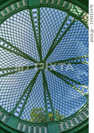 Architectural detail. Iron roof design of gazebo. Iron framed ceiling roof of alcove. Detailed architecture. Iron structure dome background. Dome roof 134831476