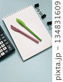 Notebook with calculator and pens on a blue background 134831609