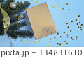 Golden gift box with fir branches on a blue background 134831610