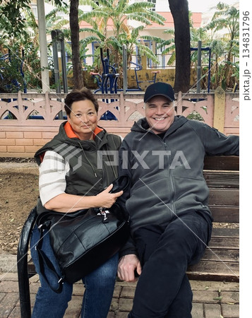 Elderly partners sitting together on bench during pleasant city walk 134831796