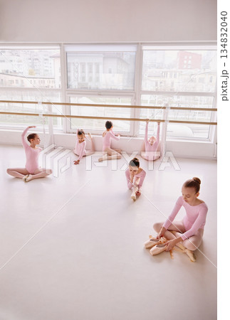 Wide view of ballet class with children practicing at barre. 134832040