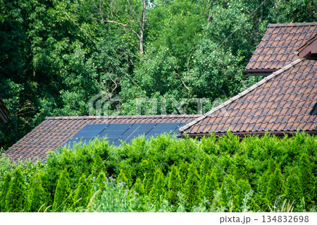 House roof with photovoltaic modules. Historic farm house with modern solar panels on roof and wall High quality photo House roof with photovoltaic modules. Historic farm house with modern solar panels on roof and wall High quality photo 134832698