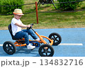 boy driving quad bike, four wheel cycle car, spring brightly morning, sunny day. High quality photo 134832716