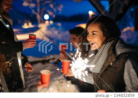 New Year celebration with friends in mountain cabin. New Year celebration with friends in mountain cabin. 134832859