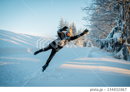 Man jumping into snow, enjoying winter time in nature. 134832867