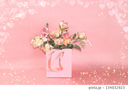 Concept for Valentine's Day or Women's Day. Postcard, hearts and flowers in gift boxes on a pink background, place for text, banner, Happy holidays, congratulations, birthday, wedding, selective focus 134832923