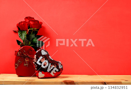 Concept for Valentine's Day or Women's Day, Mother's Day, banner. Greeting card, roses, hearts and gift boxes on a red background, happy holiday, birthday greetings, selective focus 134832951