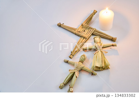 Brigid's cross, corn dolly and candle celebrating imbolc 134833302