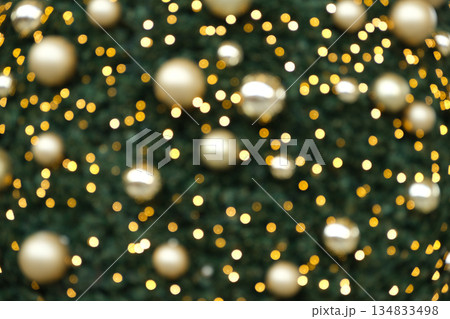 Festive Christmas Bokeh Background with Golden Ornaments and Sparkling Lights. 134833498