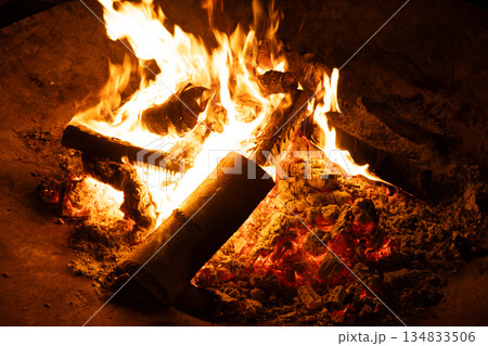 Close-up of Logs Burning with Intense Yellow and Orange Flames. 134833506