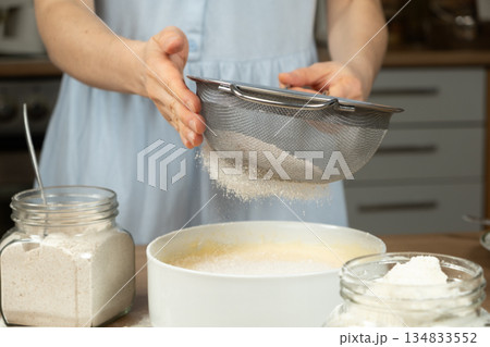 Female Hands Sifting Flour for Homemade Baking Female Hands Sifting Flour for Homemade Baking 134833552