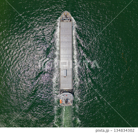 Container ship. Shipping logistics. Commercial shipping. Cargo ship in sea, aerial view. Freight container loaded on cargo vessel. Aerial cargo ship with container. Cargo business. Ship departure 134834302