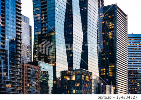 Night city skyscraper. Business skyscraper building. Architectural building in business district. Glass skyscraper at night. Night cityscape. City architecture. Architecture of modern office building Night city skyscraper. Business skyscraper building. Architectural building in business district. Glass skyscraper at night. Night cityscape. City architecture. Architecture of modern office building 134834327