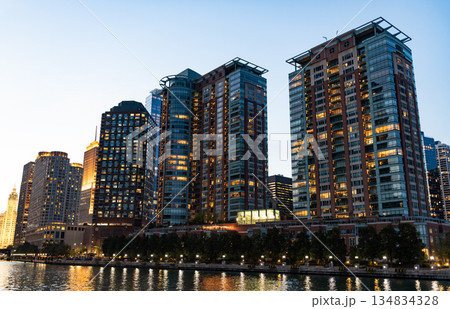 Architectural Chicago city downtown. Skyscraper architecture. City cityscape. Cityscape with building. Downtown architecture and river. Illuminated city. Chicago River cruises in City Architectural Chicago city downtown. Skyscraper architecture. City cityscape. Cityscape with building. Downtown architecture and river. Illuminated city. Chicago River cruises in City 134834328