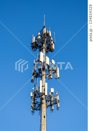 Cell phone tower. Wireless communication. Mobile service. Modern telecommunications infrastructure. Antenna technology of cellular base station. Cell site tower. Broadcasting tower station Cell phone tower. Wireless communication. Mobile service. Modern telecommunications infrastructure. Antenna technology of cellular base station. Cell site tower. Broadcasting tower station 134834329