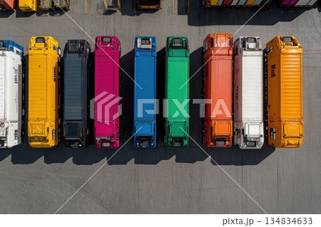 A row of brightly colored delivery trucks parked in a lot, viewed from above 134834633