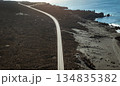 View from above on the road among black basalt rocks and lava formations. 134835382