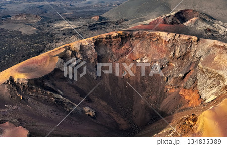 A beautiful view of a volcano crater, desert, mountains and volcanoes on the Lanzarote island. 134835389