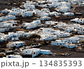 White buildings, town among volcanic black mountains and lava formations in Lanzarote, Canary Islands. 134835393