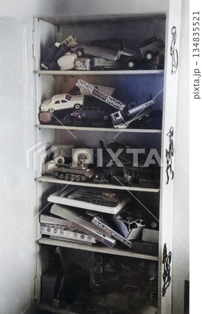 A vintage photograph of a collection of boys' toys. Cars, tanks, and other items are displayed on shelves. Photo from 1972. 134835521