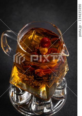 Hot tea in a cup on an old background. 134835890