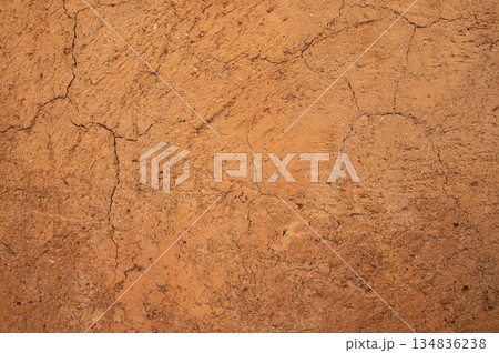 Full frame shot of an earthen wall texture of clay house structure. These walls are constructed by ramming a mixture of aggregates, including gravel, sand, silt and a small amount of clay. Full frame shot of an earthen wall texture of clay house structure. These walls are constructed by ramming a mixture of aggregates, including gravel, sand, silt and a small amount of clay. 134836238