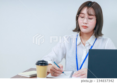 デスクワーク中に居眠りをしてしまう女性 デスクワーク中に居眠りをしてしまう女性 134837342
