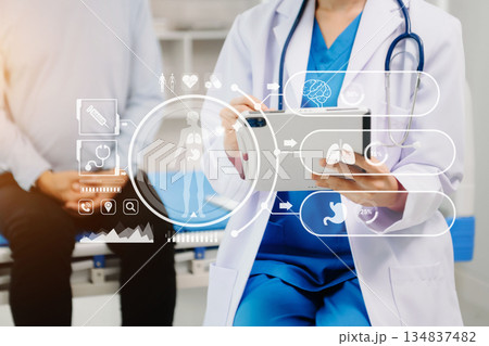Doctor works with mobile devices on the Internet in the office. on hologram modern virtual icon Doctor works with mobile devices on the Internet in the office. on hologram modern virtual icon 134837482