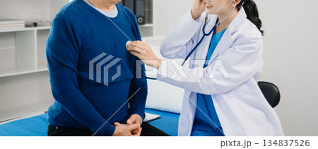Doctor discussing treatment with Senior male patient talking and laughing sitting on examination bed in clinic or hospital Doctor discussing treatment with Senior male patient talking and laughing sitting on examination bed in clinic or hospital 134837526