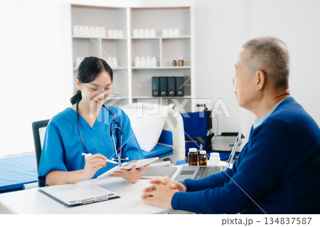 Asia female doctor using clipboard is delivering great news talk discuss results or symptoms with female patient in clinic 134837587