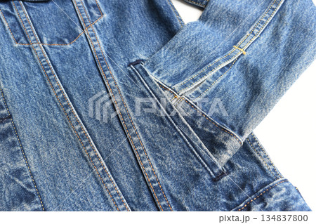 sleeve of blue denim shirt texture isolated on white background, jean fashion style 134837800