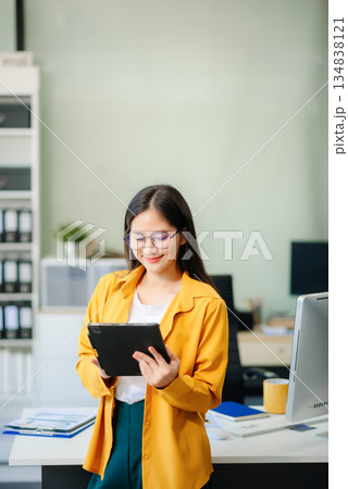 Young businesswoman standing in the boardroom of a modern office. Young businesswoman standing in the boardroom of a modern office. 134838121