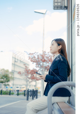 バス停で就職活動を考える日本人女子大学生 134838926