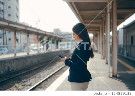 駅のホームでスマホを操作する日本人女子大学生 134839132