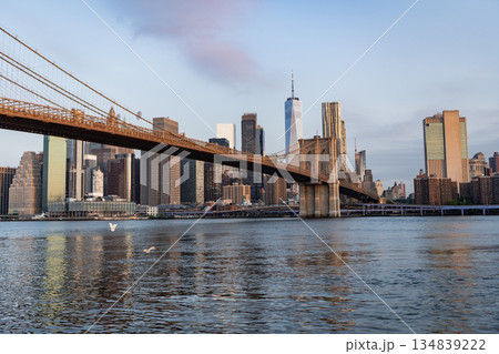 Brooklyn bridge to Manhattan on sunset. Urban architecture of New York city. Brooklyn bridge of New York city. Brooklyn landmark. Manhattan cityscape with skyscraper architecture 134839222