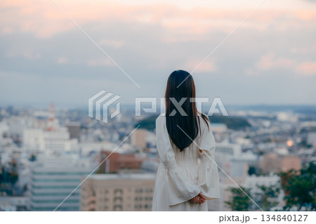 街並みを背景に佇む日本人女性 街並みを背景に佇む日本人女性 134840127