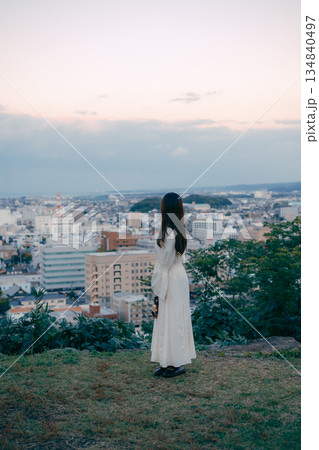 街を見下ろす高台でランタンを持つ女性 134840497