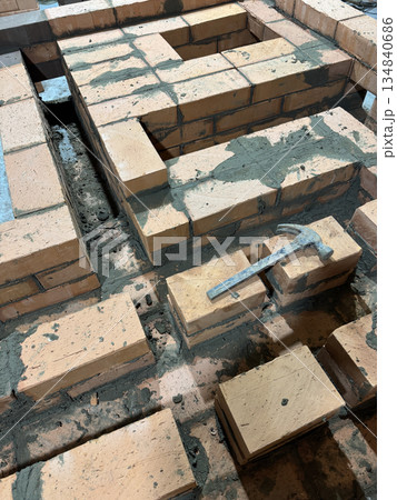 Brickwork of the stove and bench of a heating stove. 134840686