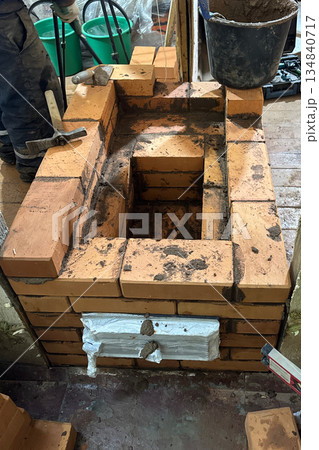 Construction of a heating stove. Fresh brickwork of the stove firebox. 134840717