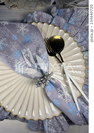 Table setting. Cutlery and napkins. Winter theme. Shot from above. 134840720