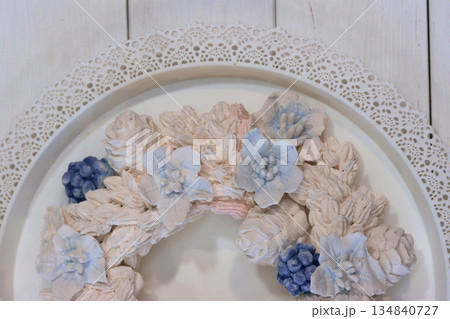 Marshmallow wreath. Wreath made of marshmallow flowers. Shot from above, half of the wreath close-up. Marshmallow wreath. Wreath made of marshmallow flowers. Shot from above, half of the wreath close-up. 134840727