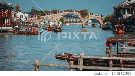 Crowded Stone Arch Bridge Surrounded by Boats and Historical Buildings. Zhujiajiao, Shanghai, China Crowded Stone Arch Bridge Surrounded by Boats and Historical Buildings. Zhujiajiao, Shanghai, China 134842395