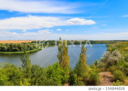 Summer landscape with beautiful river, green trees and blue sky 134844026
