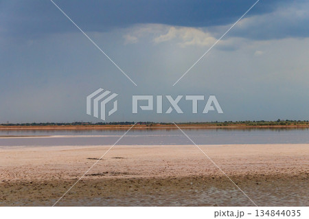Dark storm clouds over a salt lake before a rain 134844035