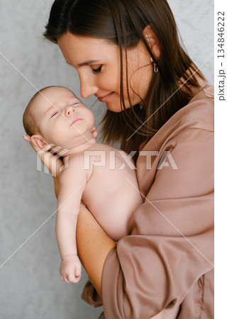 Mother Gently Cuddling Sleeping Newborn Baby 134846222