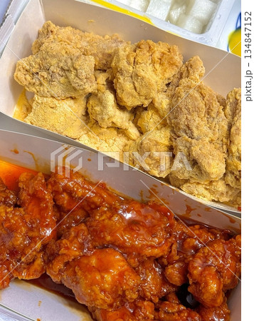 Crispy Korean fried chicken, perfectly glazed with a sweet and spicy sauce. Ideal for food photography and menus, showcasing the irresistible crunch and flavor of this beloved dish. 134847152