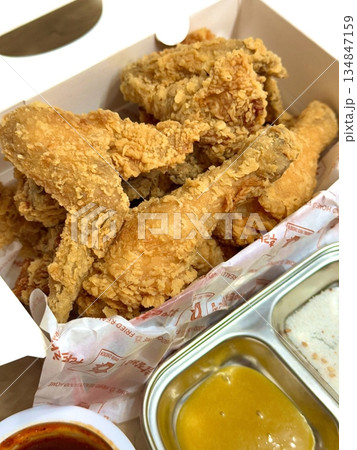 Crispy Korean fried chicken, perfectly glazed with a sweet and spicy sauce. Ideal for food photography and menus, showcasing the irresistible crunch and flavor of this beloved dish. Crispy Korean fried chicken, perfectly glazed with a sweet and spicy sauce. Ideal for food photography and menus, showcasing the irresistible crunch and flavor of this beloved dish. 134847159