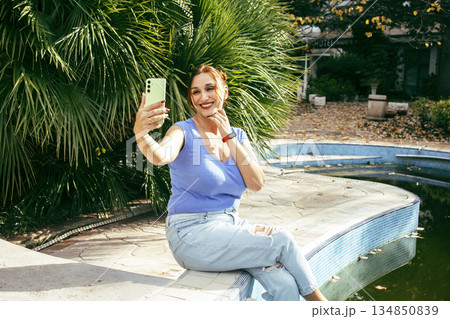 young pretty woman talking on phone at swimming pool, lifestyle people concept young pretty woman talking on phone at swimming pool, lifestyle people concept 134850839