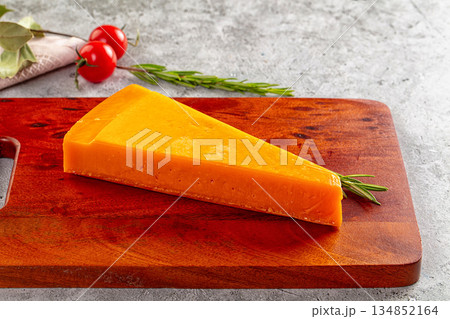Yellow cheddar cheese over board 134852164
